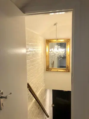a bathroom with a mirror and a chandelier at Luxury Apartment in Blackpool