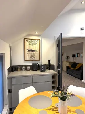 a dining room with a table and a living room at Luxury Apartment in Blackpool