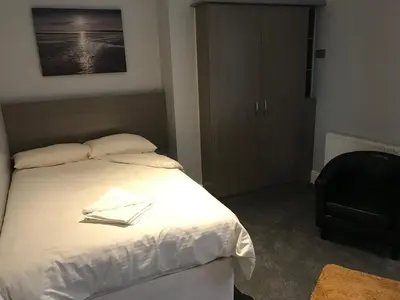 a bedroom with a bed with two books on it at Lexham Hotel in Blackpool