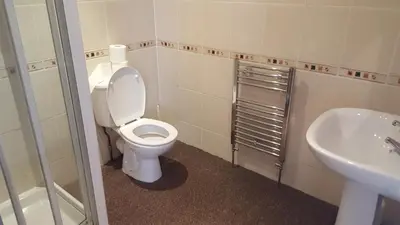 a bathroom with a toilet and a sink at Lexham Hotel in Blackpool