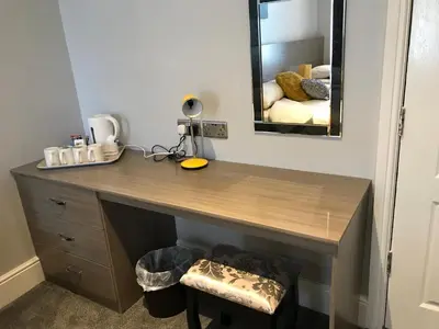 a wooden desk in a room with a mirror at Lexham Hotel in Blackpool