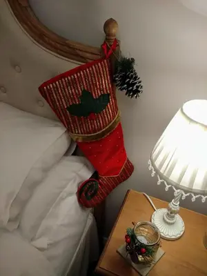 a stocking hanging on a bed next to a table at Coachhousebungalow in Grange Over Sands