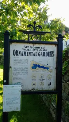a sign that says welcome to change over campsincial gardens at Coachhousebungalow in Grange Over Sands