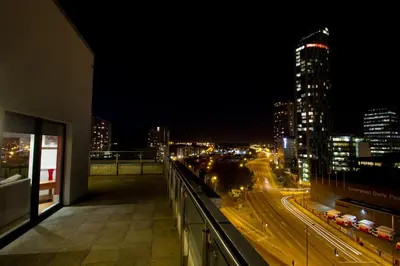 a view of a city at night from a building at Merchant Quarters Apartments in Liverpool