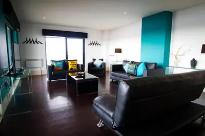 a living room with two couches and a table at Merchant Quarters Apartments in Liverpool