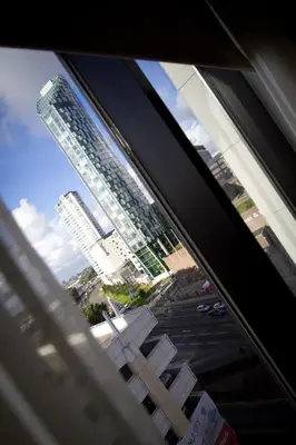 a view of a city from a window at Merchant Quarters Apartments in Liverpool