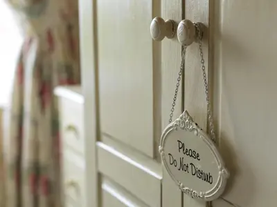 a door knob with a sign that reads praise do not disturb at Howarth House in Lytham St Annes
