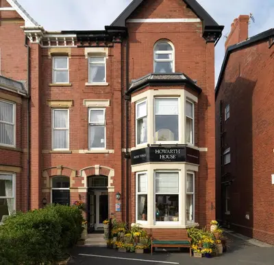 a brick building with a bench in front of it at Howarth House in Lytham St Annes