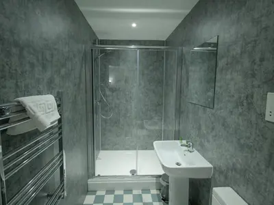 a bathroom with a shower and a toilet and a sink at The Royal Hotel and Bar in Lancaster