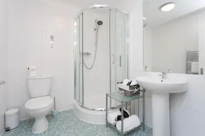 a bathroom with a toilet and a sink and a shower at The Royal Hotel and Bar in Lancaster