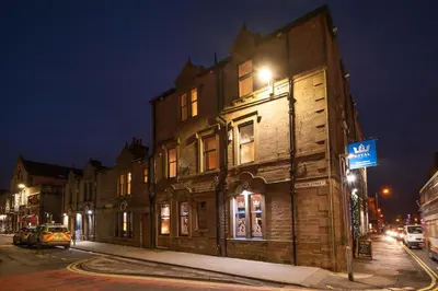 an old building on a city street at night at The Royal Hotel and Bar in Lancaster