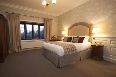a bedroom with a large bed and a window at Netherwood Hotel & Spa in Grange Over Sands