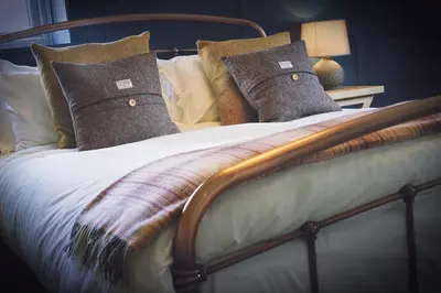 a bed with pillows and a blanket on it at Pyes Mill Hotel Conder Green in Conder Green