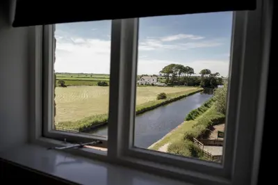 a window with a view of a river at Pyes Mill Hotel Conder Green in Conder Green