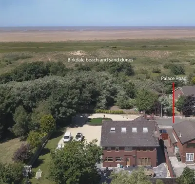 an aerial view of the britishews beach and sand dunes village house at Orchid House in Southport