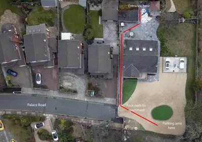 an aerial view of a parking lot with a red line separating a building at Orchid House in Southport