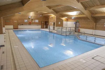 a large swimming pool in a building at Pine Lake Resort in Carnforth