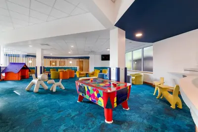 a childrens play room with a pool table and chairs at Pine Lake Resort in Carnforth