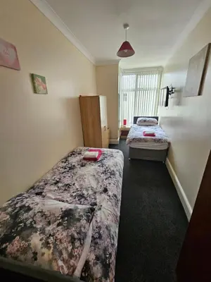 a bedroom with two beds and a window at Bayswater House in Blackpool