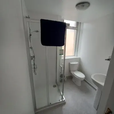 a bathroom with a shower and a toilet at Bayswater House in Blackpool