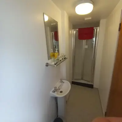 a bathroom with a toilet and a sink and a shower at Bayswater House in Blackpool