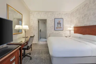 a hotel room with a bed and a desk and a television at Delta Hotels by Marriott Preston in Preston
