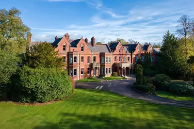 a large red brick house with a driveway at Delta Hotels by Marriott Preston in Preston