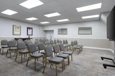 a room with rows of chairs and a podium at Delta Hotels by Marriott Preston in Preston
