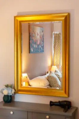 a mirror on top of a dresser in a bedroom at The Lower Buck Inn in Clitheroe