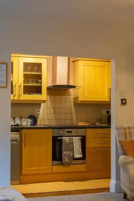 a kitchen with yellow cabinets and an oven at The Lower Buck Inn in Clitheroe