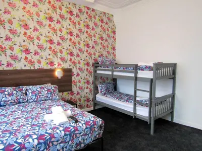 a bedroom with a bed and a bunk bed at Belroy Hotel in Blackpool