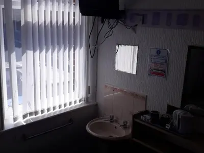 a bathroom with a sink and a window at Belroy Hotel in Blackpool