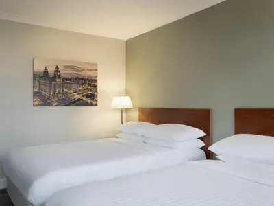 a hotel room with two beds and a painting on the wall at Delta Hotels by Marriott Liverpool City Centre in Liverpool