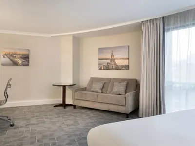 a hotel room with a couch and a window at Delta Hotels by Marriott Liverpool City Centre in Liverpool