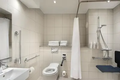 a bathroom with a toilet and a sink and a shower at Delta Hotels by Marriott Liverpool City Centre in Liverpool