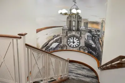 a mural of a clock on a wall at Delta Hotels by Marriott Liverpool City Centre in Liverpool
