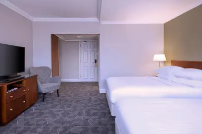 a hotel room with a bed and a flat screen tv at Delta Hotels by Marriott Liverpool City Centre in Liverpool