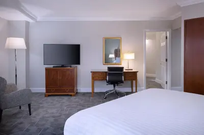 a hotel room with a bed and a desk and a television at Delta Hotels by Marriott Liverpool City Centre in Liverpool