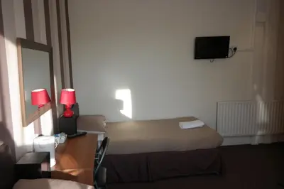a hotel room with a bed and a mirror at Boomerang Blackpool in Blackpool