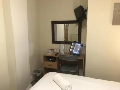 a hotel room with a desk with a mirror at Boomerang Blackpool in Blackpool