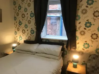 a bedroom with a bed and a window at Boomerang Blackpool in Blackpool