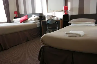 a hotel room with two beds with towels on them at Boomerang Blackpool in Blackpool