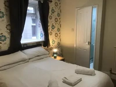 a bedroom with a large white bed with a window at Boomerang Blackpool in Blackpool