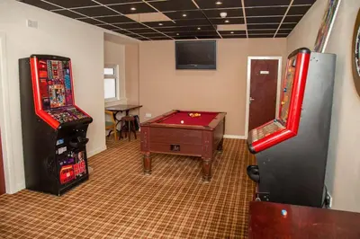 a room with two arcade games and a pool table at The Trafford Hotel in Blackpool