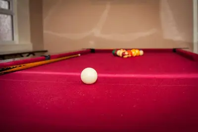 a pool table with two balls and two cuesticks at The Trafford Hotel in Blackpool