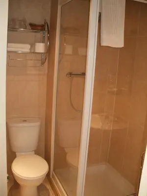 a bathroom with a toilet and a shower at The Trafford Hotel in Blackpool