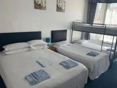 two beds in a room with two bunk beds at The Mornington Hotel in Blackpool