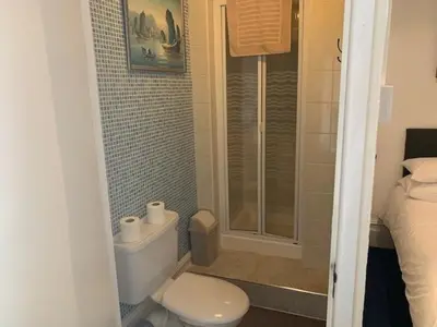 a small bathroom with a toilet and a shower at The Mornington Hotel in Blackpool