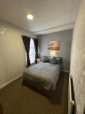 a bedroom with a bed and a window at Clifton Private Hotel in Blackpool