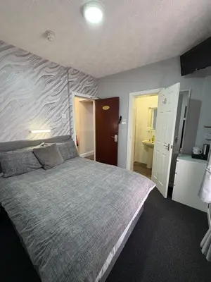a bedroom with a large bed in a room at Clifton Private Hotel in Blackpool